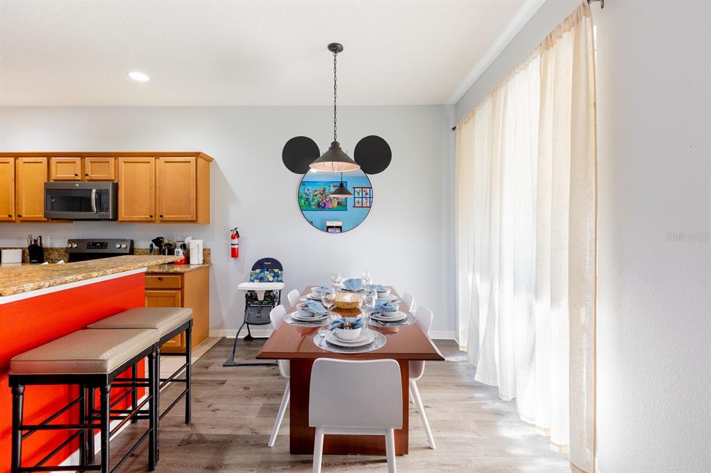 891 Assembly Court Reunion, FL 34747 - Photo 5 of 54 a dining room with a window and stainless steel appliances