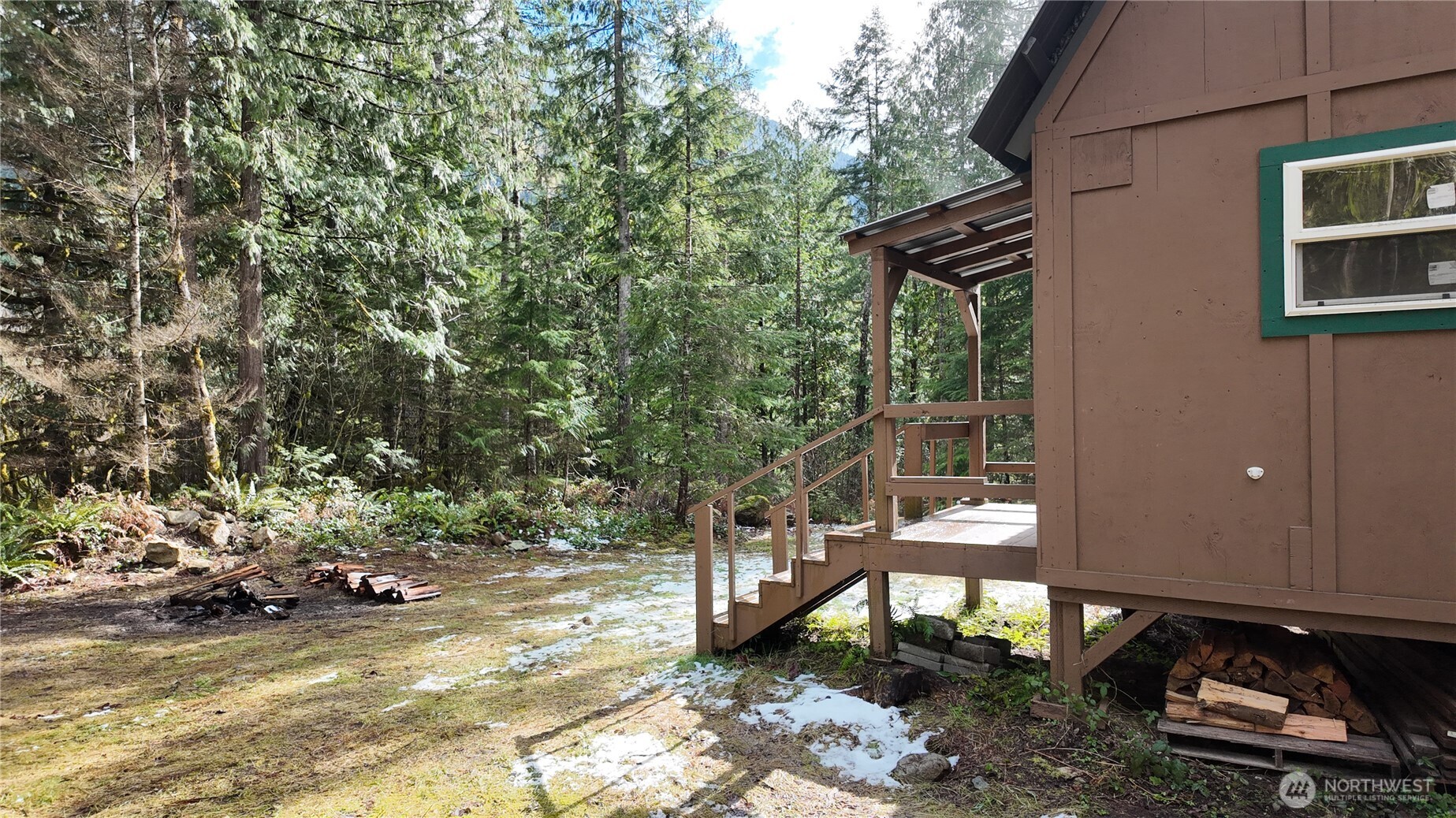 64084 Cascade River Road, Unit D1204 Marblemount, WA 98267 - Photo 3 of 26 a view of a patio with table and chairs and wooden fence