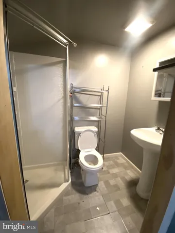 a bathroom with a toilet and a shower