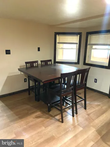 a room with furniture pool table and windows