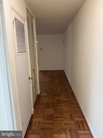 an empty room with windows and entrance