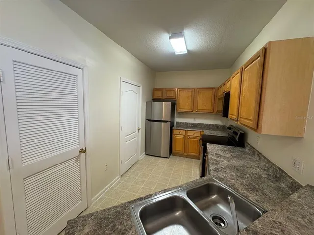 a kitchen with a refrigerator sink and stove