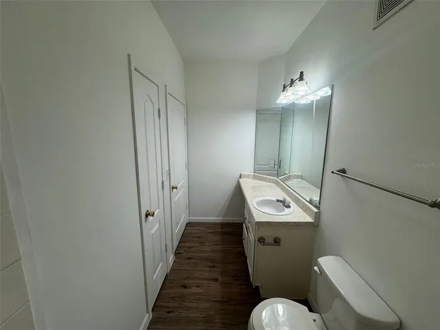 a bathroom with a sink toilet and mirror