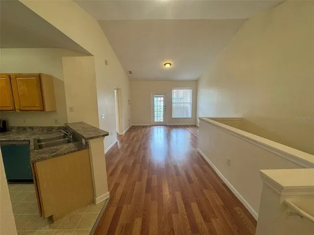 a kitchen with sink and refrigerator