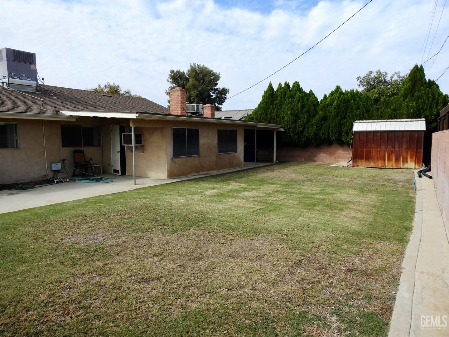 Undisclosed Address Bakersfield, CA 93308 - Photo 16 of 18 a backyard of a house with table and chairs