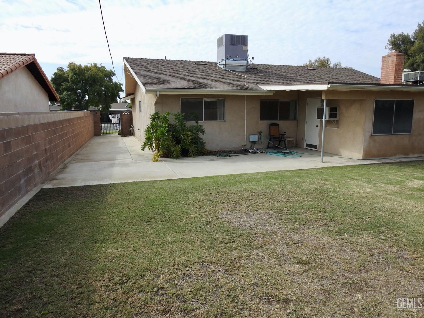 Undisclosed Address Bakersfield, CA 93308 - Photo 17 of 18 a front view of a house with a garden