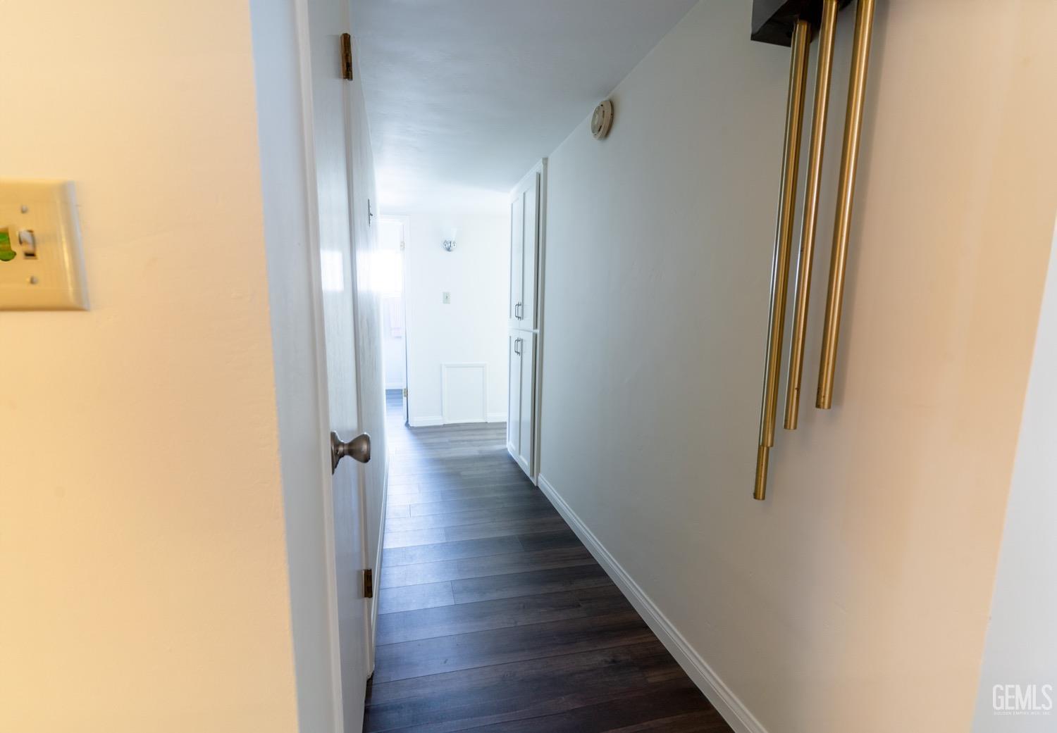 Undisclosed Address Bakersfield, CA 93308 - Photo 9 of 18 a view of a hallway with wooden floor
