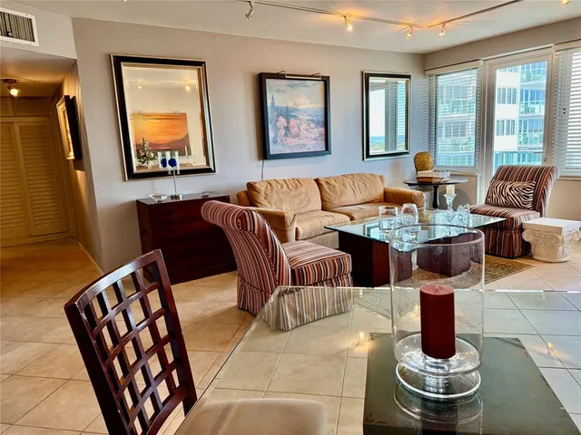 a living room with furniture flowerpot and window