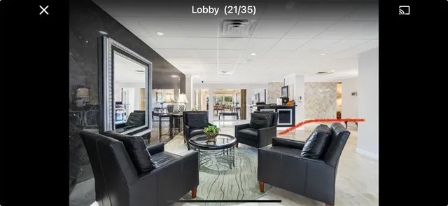 a dining room with furniture and a chandelier