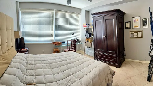 a bedroom with a bed next to a window