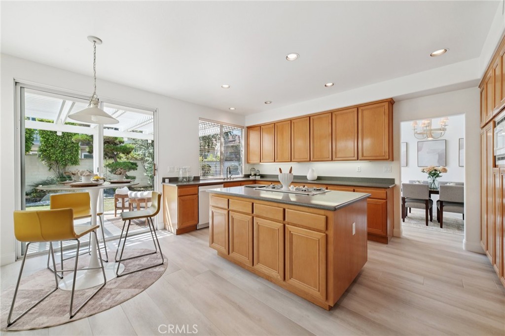 12440 Butler Way Tustin, CA 92782 - Photo 11 of 65 View of kitchen. Great view in front of sink of the back yard with water feature. Plenty of storage! Doorway on the right leads to the dining room.