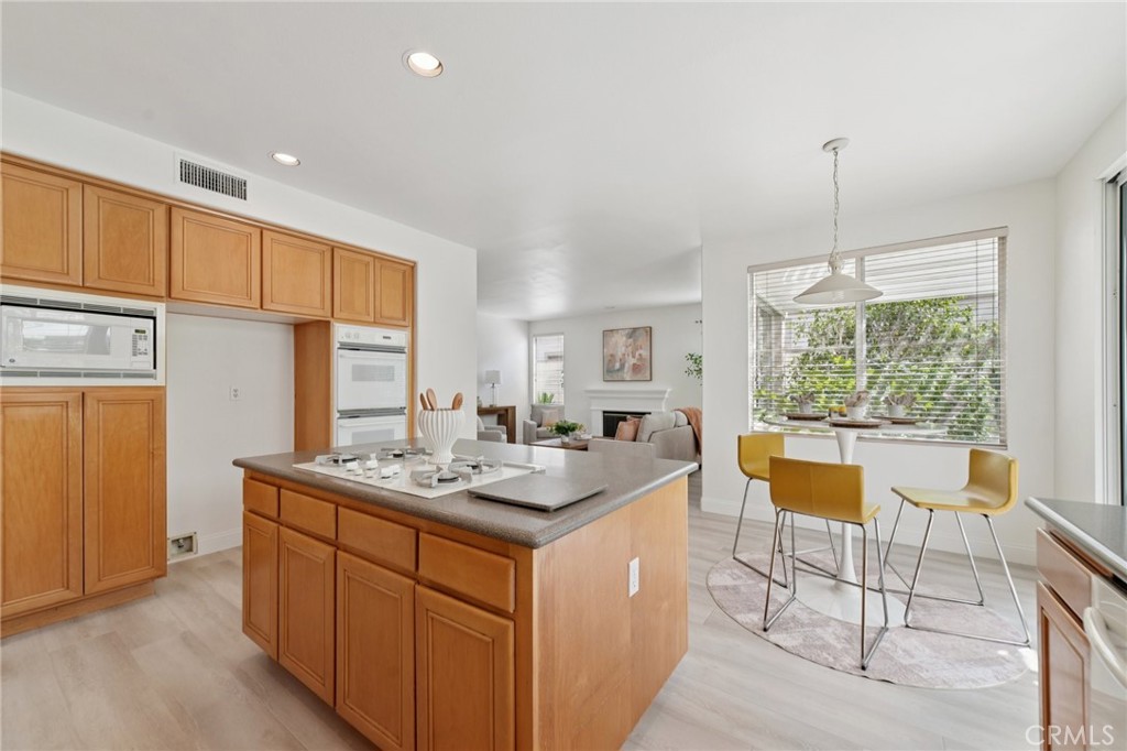 12440 Butler Way Tustin, CA 92782 - Photo 12 of 65 Kitchen view towards family room. Double oven, microwave, dishwasher. Island boasts a lot of storage!