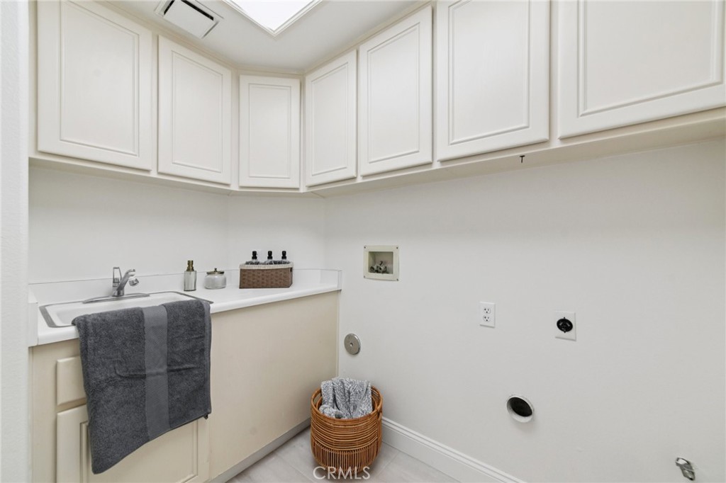 12440 Butler Way Tustin, CA 92782 - Photo 15 of 65 Laundry room complete with sink and cabinets. Located just in side the door from the garage.