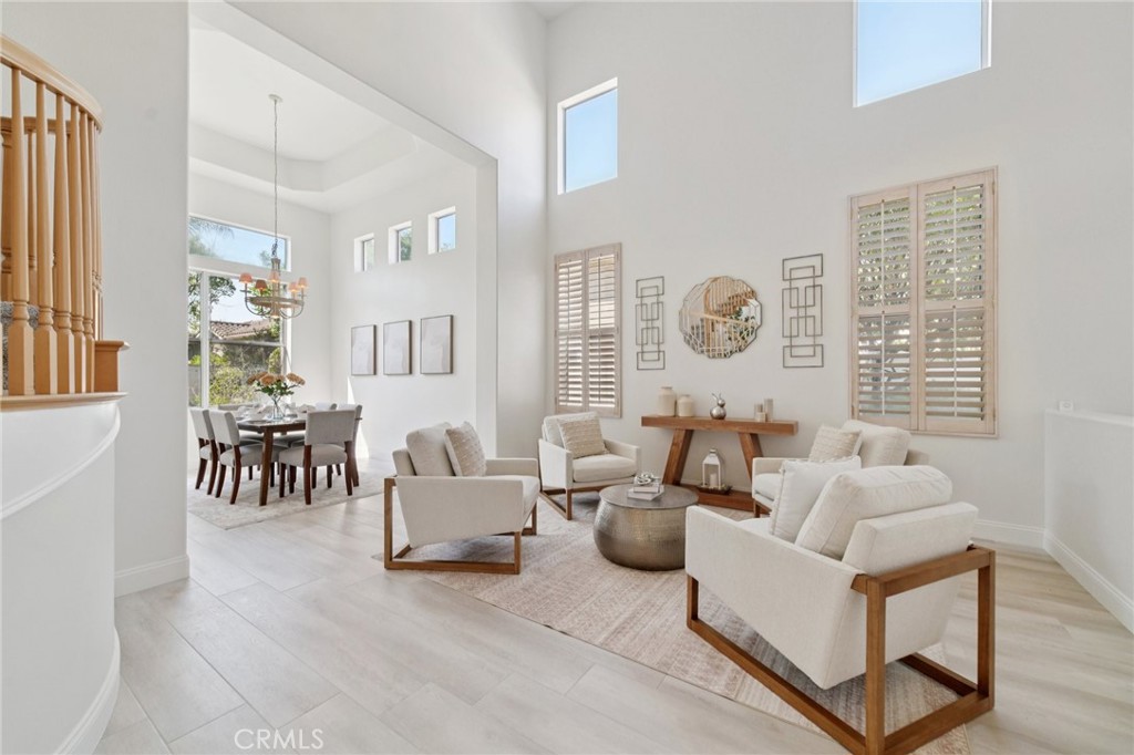 12440 Butler Way Tustin, CA 92782 - Photo 20 of 65 View of the living room, dining room from the hallway going to the first level bedroom, bathroom, laundry room and garage. Lots of natural light!