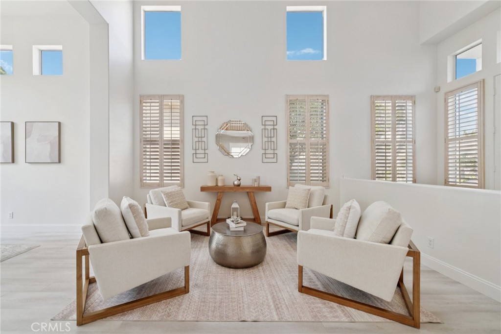 12440 Butler Way Tustin, CA 92782 - Photo 21 of 65 View of the living room with shutters and high ceilings. Entry foyer is on the right.