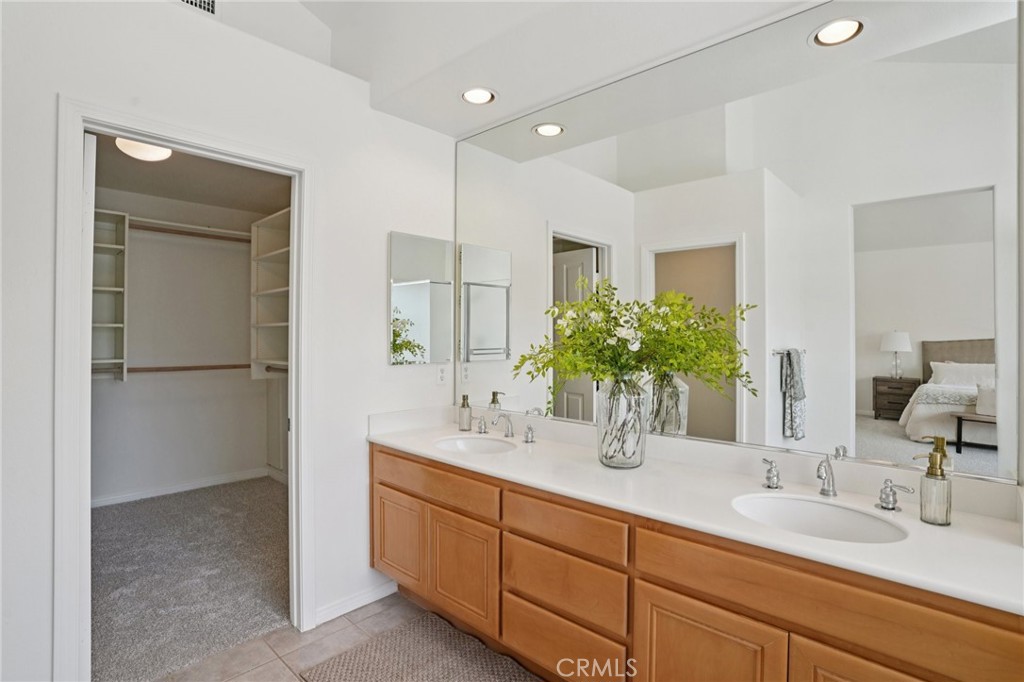 12440 Butler Way Tustin, CA 92782 - Photo 30 of 65 View of large custom organized walk in closet and the dual sink vanity.