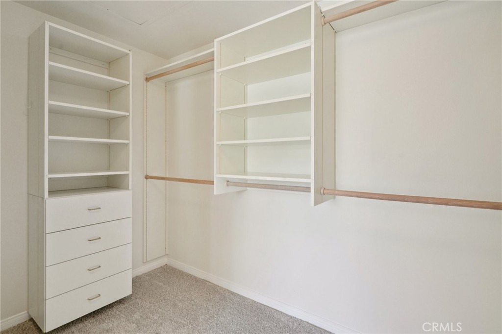 12440 Butler Way Tustin, CA 92782 - Photo 31 of 65 Custom organized walk in closet in the primary bedroom.