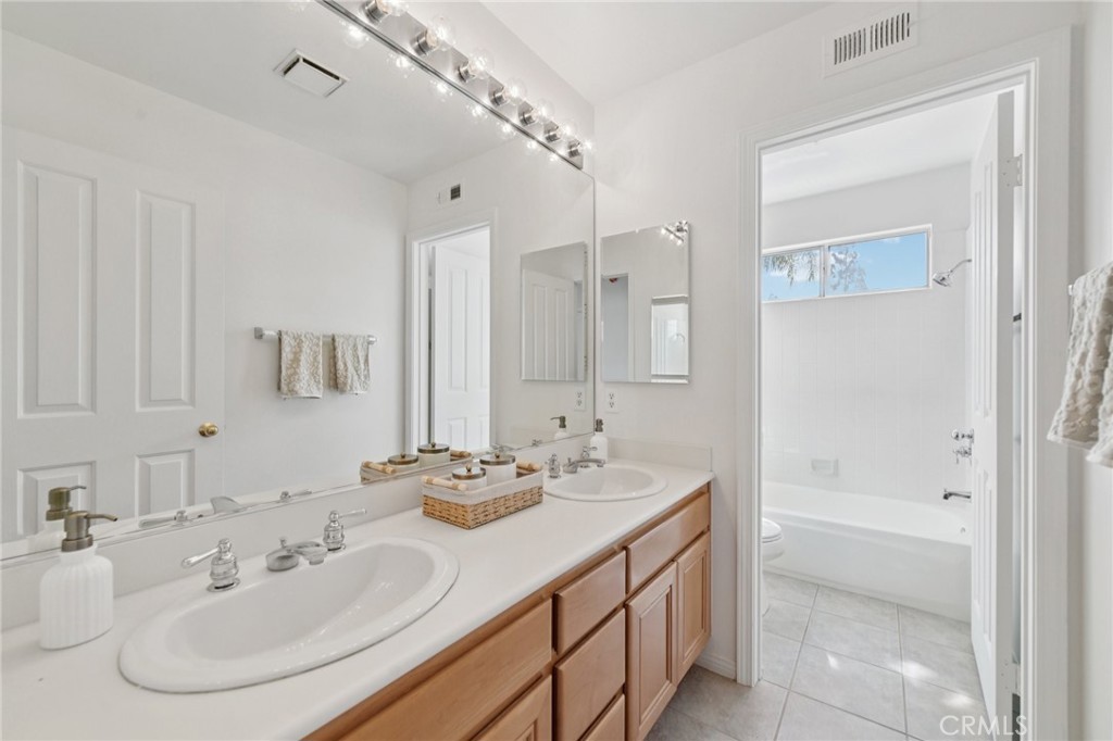 12440 Butler Way Tustin, CA 92782 - Photo 35 of 65 Another full bathroom with dual sinks and tub/shower combination upstairs.