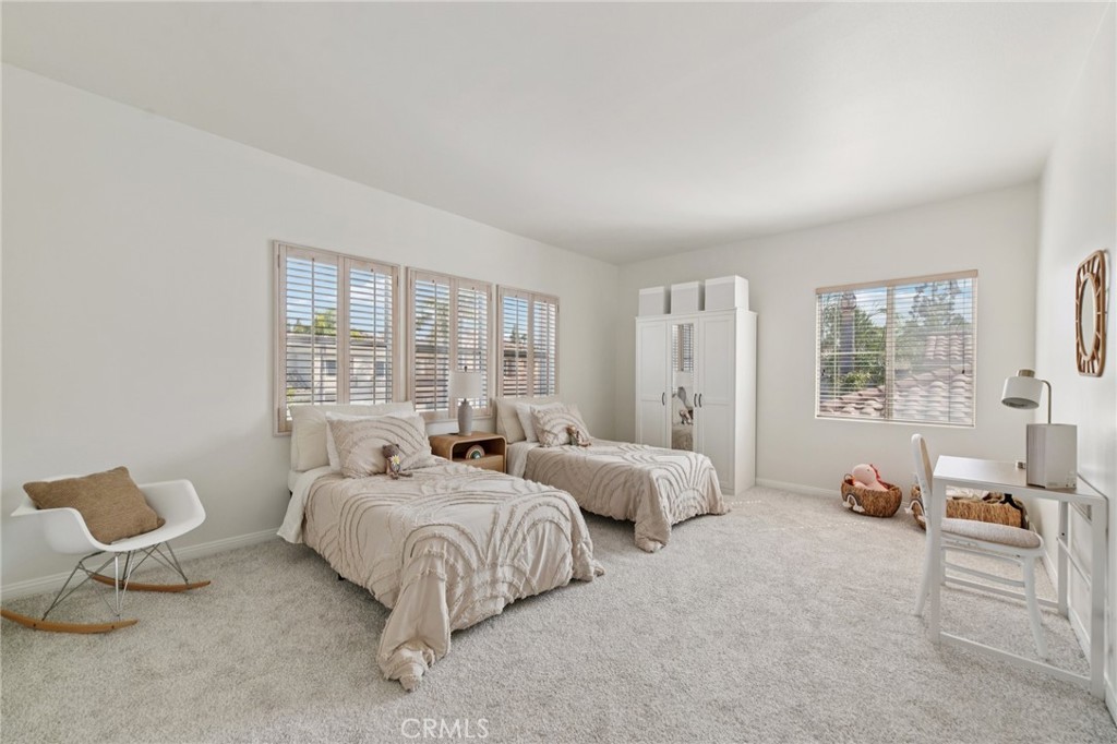 12440 Butler Way Tustin, CA 92782 - Photo 36 of 65 Very large bonus room used as bedroom with wardrobe closet. Windows above the beds face the front of the home.