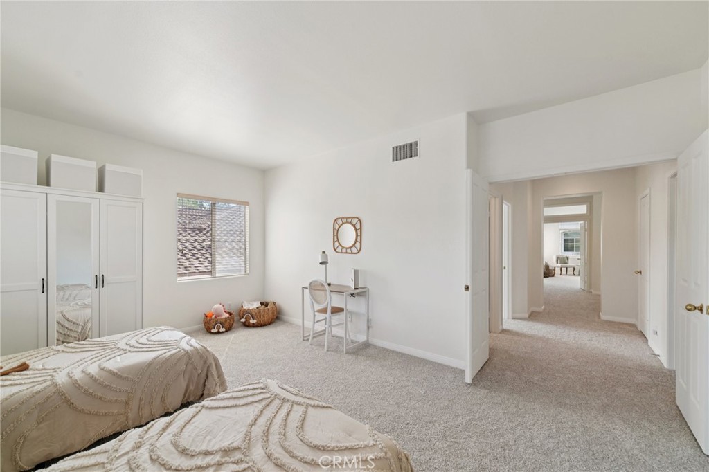 12440 Butler Way Tustin, CA 92782 - Photo 37 of 65 Bonus room view towards the double door entry and hallway. Bathroom located in the hallway on left with another bedroom on the right.