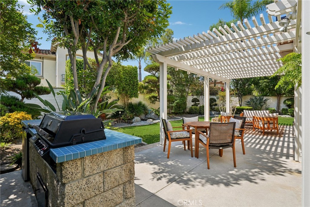 12440 Butler Way Tustin, CA 92782 - Photo 38 of 65 Great view of the gourmet barbeque island, covered patio area and back yard.