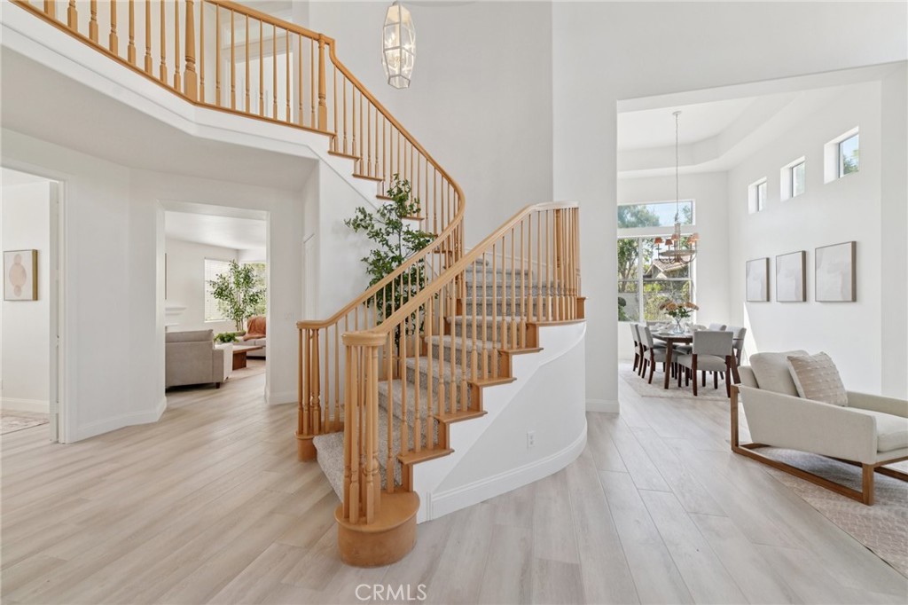 12440 Butler Way Tustin, CA 92782 - Photo 4 of 65 View as you enter the double front doors. Beautiful staircase leads upstairs to the primary bedroom, 2 additional bedrooms plus the versatile bonus room. Nice storage under the stairway.