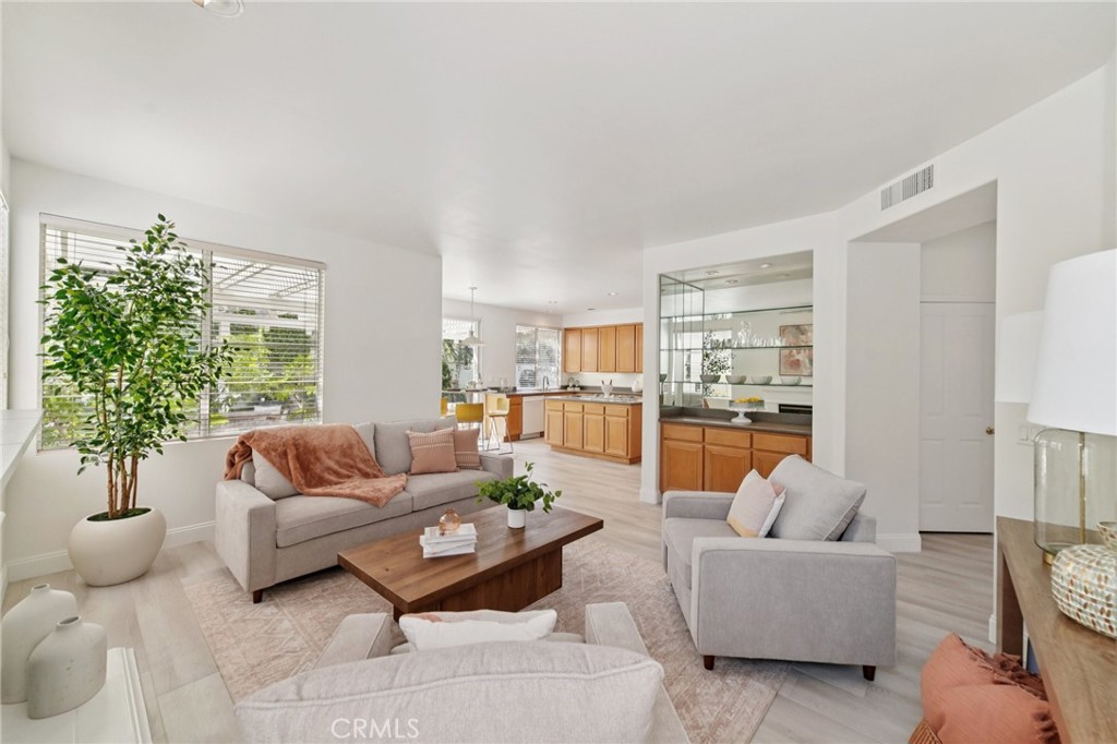 12440 Butler Way Tustin, CA 92782 - Photo 8 of 65 View from family room looking towards kitchen and breakfast nook. Built in dry bar has plenty of storage with glass shelves.