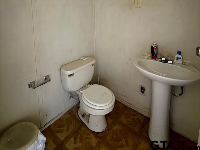 17159 County Road 1182 Flint, TX 75762 - Photo 18 of 29 a white toilet sitting next to a bathroom sink