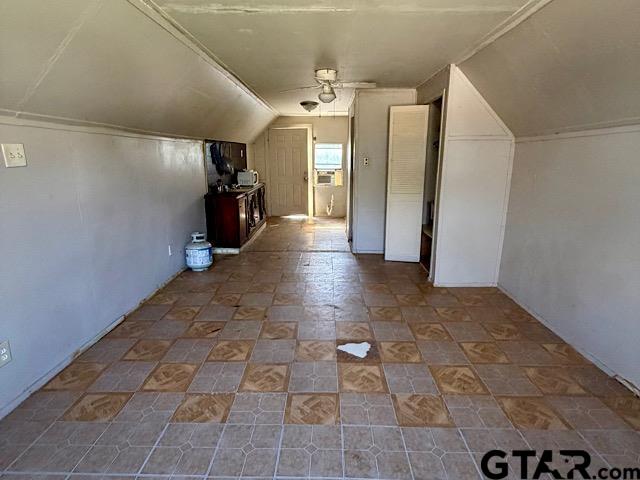 17159 County Road 1182 Flint, TX 75762 - Photo 22 of 29 a view of a hallway with wooden floor and a refrigerator