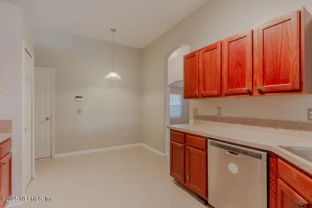 a kitchen with stainless steel appliances granite countertop a sink and a microwave with wooden cabinets