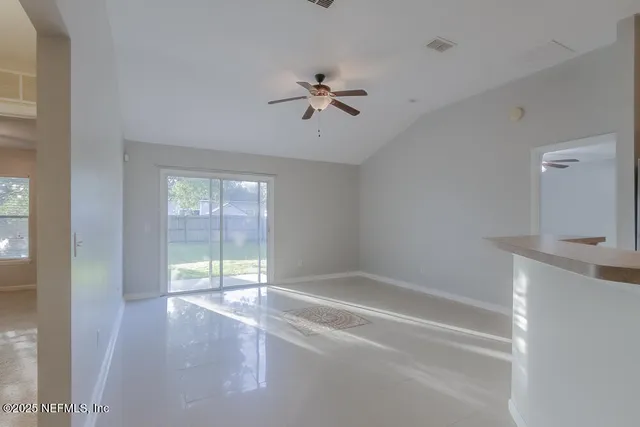a view of a livingroom with a ceiling fan and window