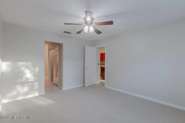 a view of empty room with ceiling fan
