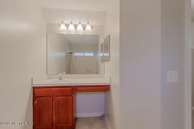 a bathroom with a sink and a mirror