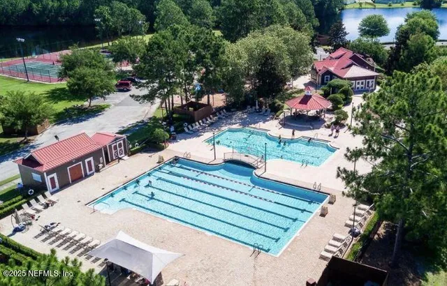 an aerial view of a house with a yard