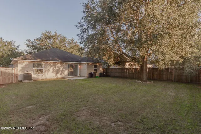 a view of a house with a backyard