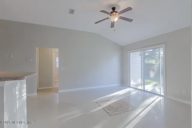 a view of room with a ceiling fan and window