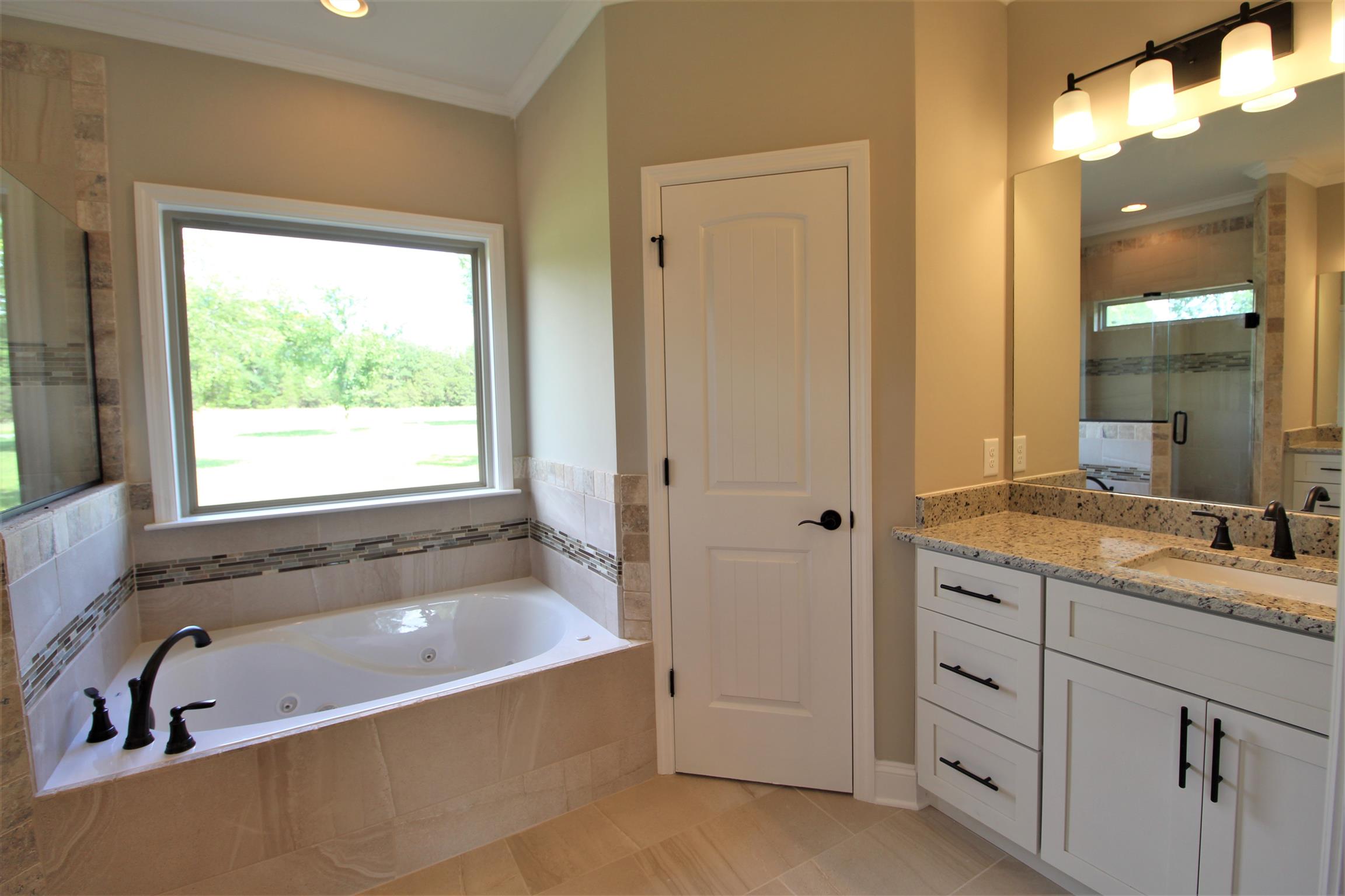 7150 Cedar Forest Road Lebanon, TN 37090 - Photo 14 of 29 a bathroom with a granite countertop tub sink and mirror