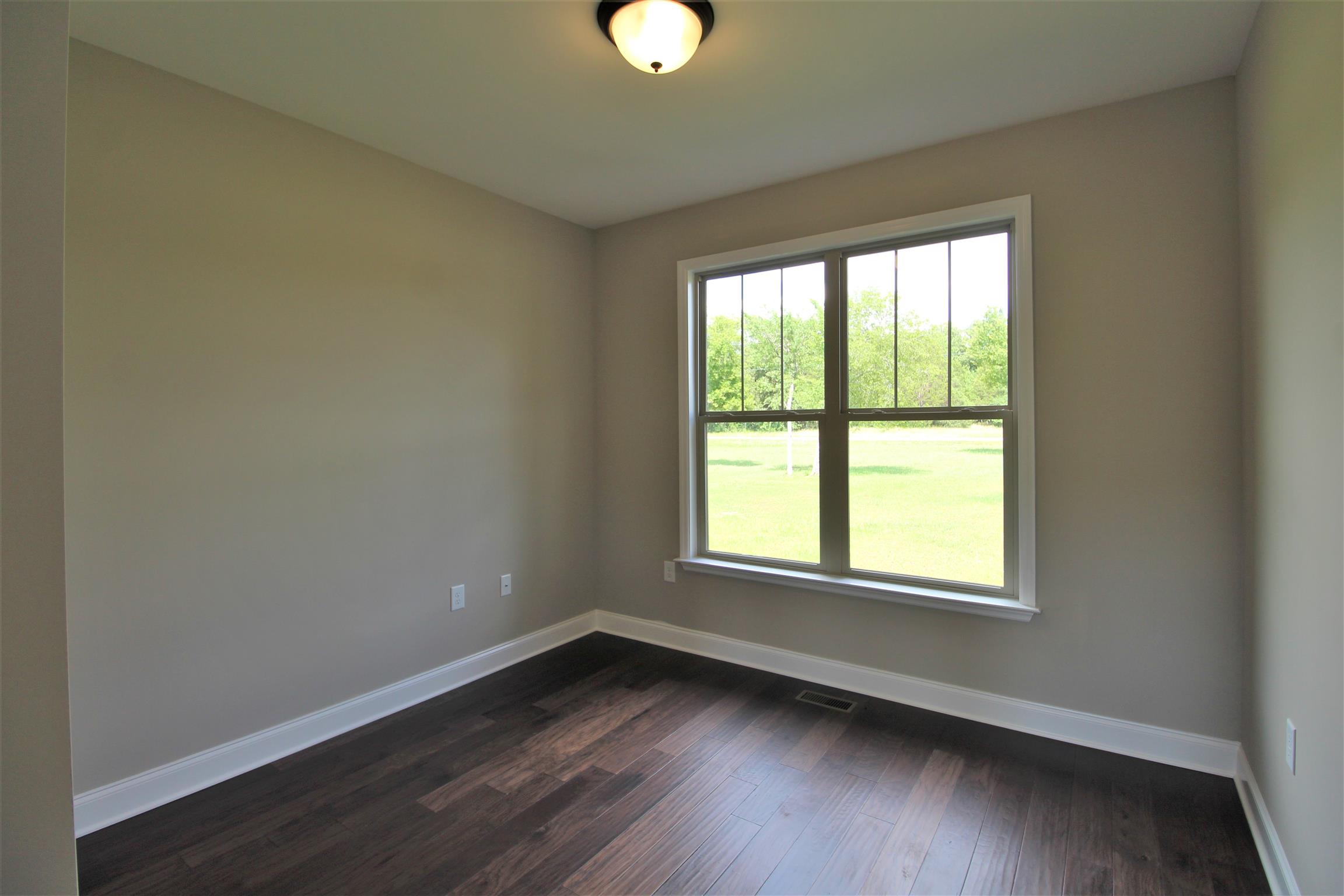 7150 Cedar Forest Road Lebanon, TN 37090 - Photo 17 of 29 a view of an empty room with wooden floor and a window