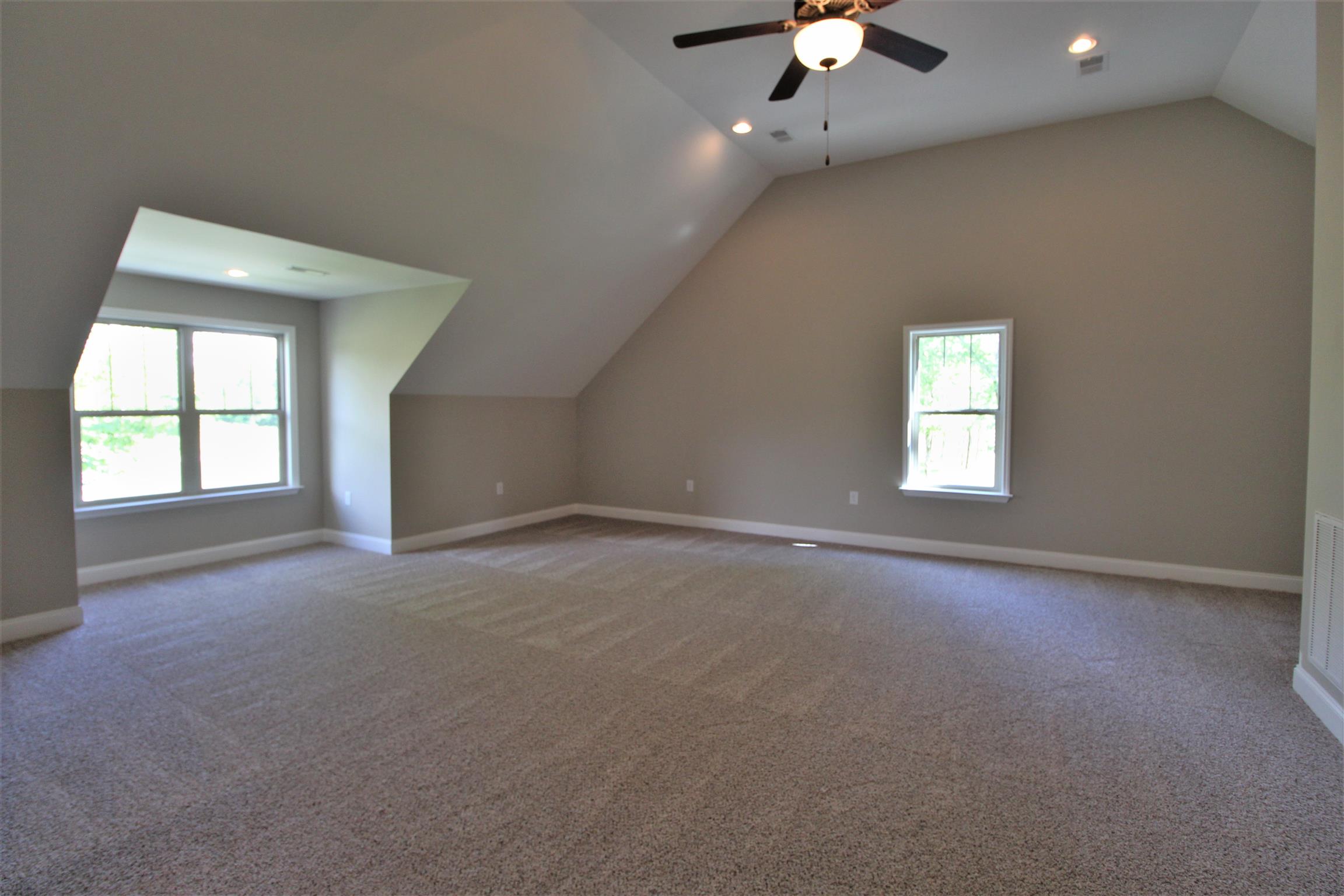 7150 Cedar Forest Road Lebanon, TN 37090 - Photo 22 of 29 an empty room with a chandelier fan and windows