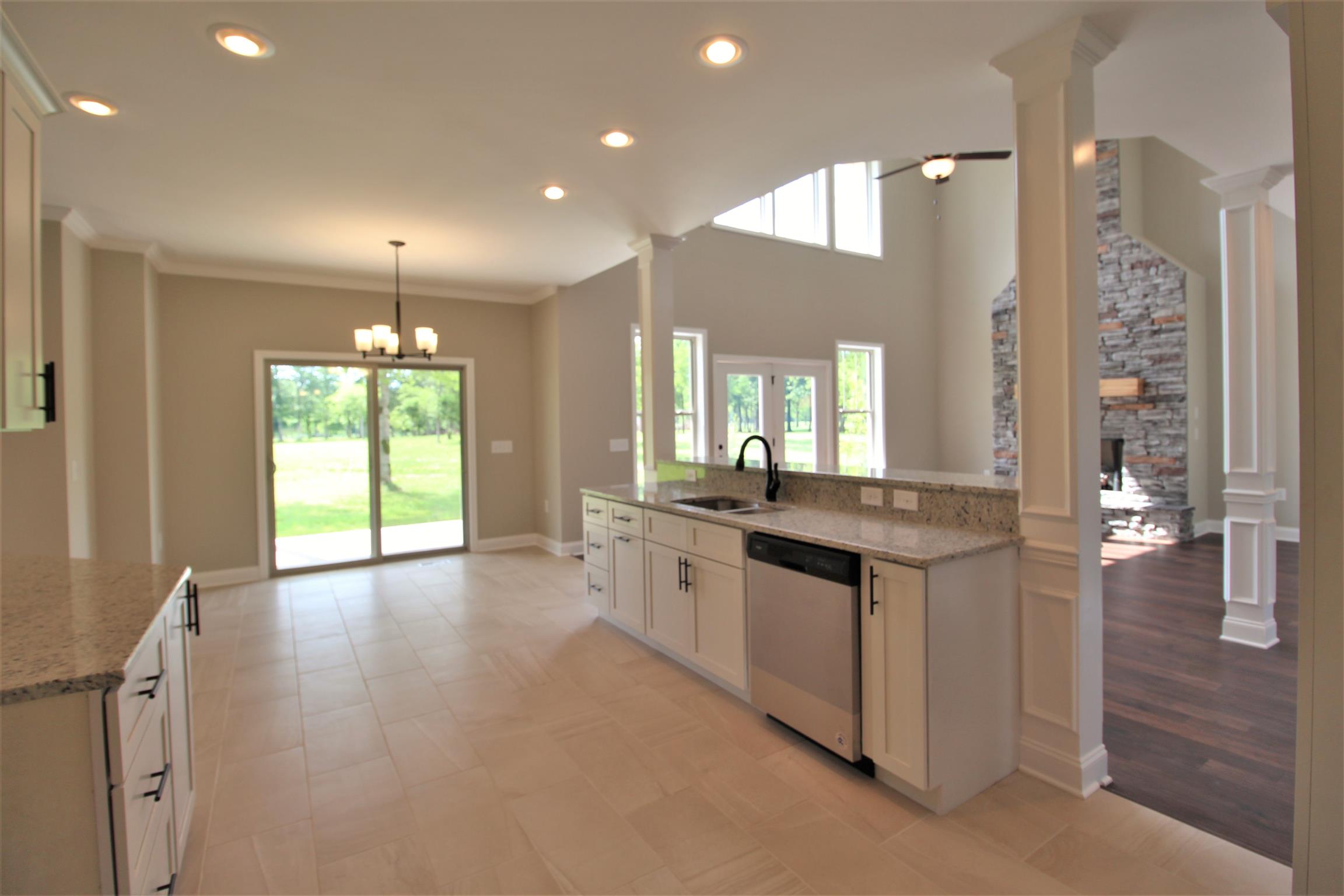 7150 Cedar Forest Road Lebanon, TN 37090 - Photo 6 of 29 a large kitchen with granite countertop a large counter top a sink and stainless steel appliances