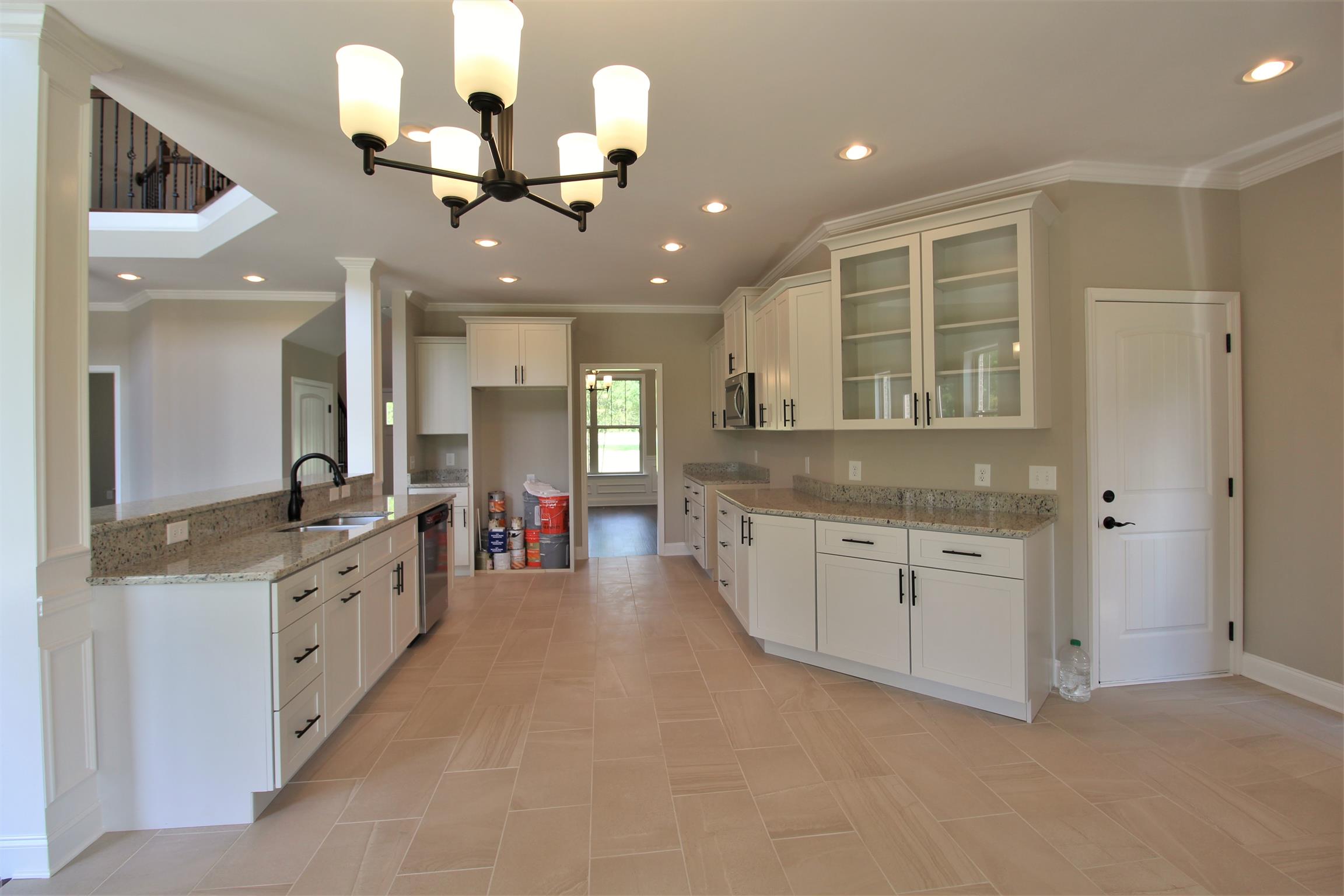 7150 Cedar Forest Road Lebanon, TN 37090 - Photo 7 of 29 a large kitchen with stainless steel appliances kitchen island granite countertop a sink and dishwasher