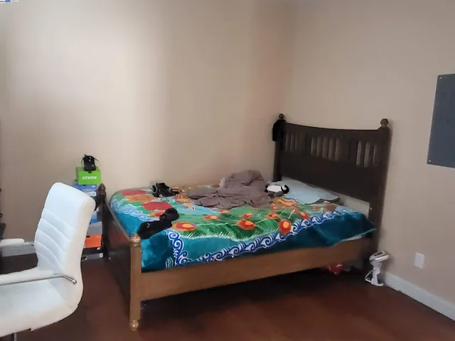 a bed sitting in a bedroom next to a window