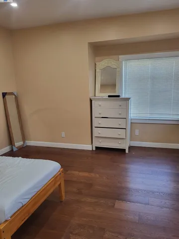 a bedroom with a bed and a mirror