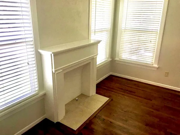 a view of a room with wooden floor and a window