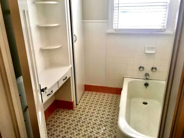 a bathroom with a bathtub and a shower