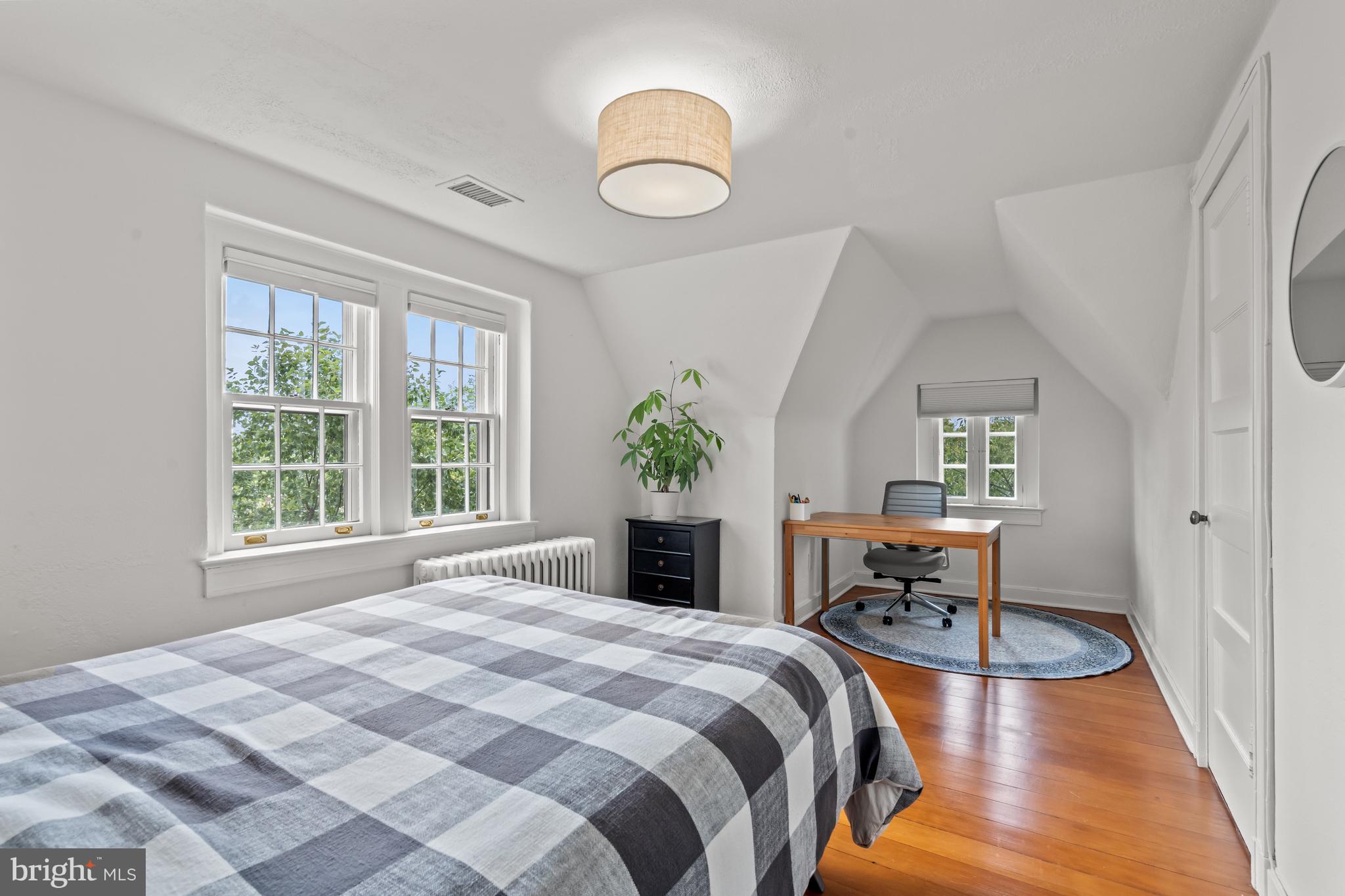 4452 Q Street Northwest Washington, DC 20007 - Photo 13 of 20 a bedroom with a bed and a chandelier