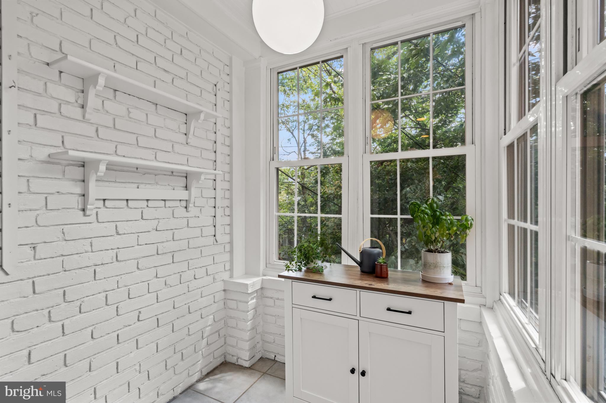 4452 Q Street Northwest Washington, DC 20007 - Photo 7 of 20 a bathroom with a window sink and mirror