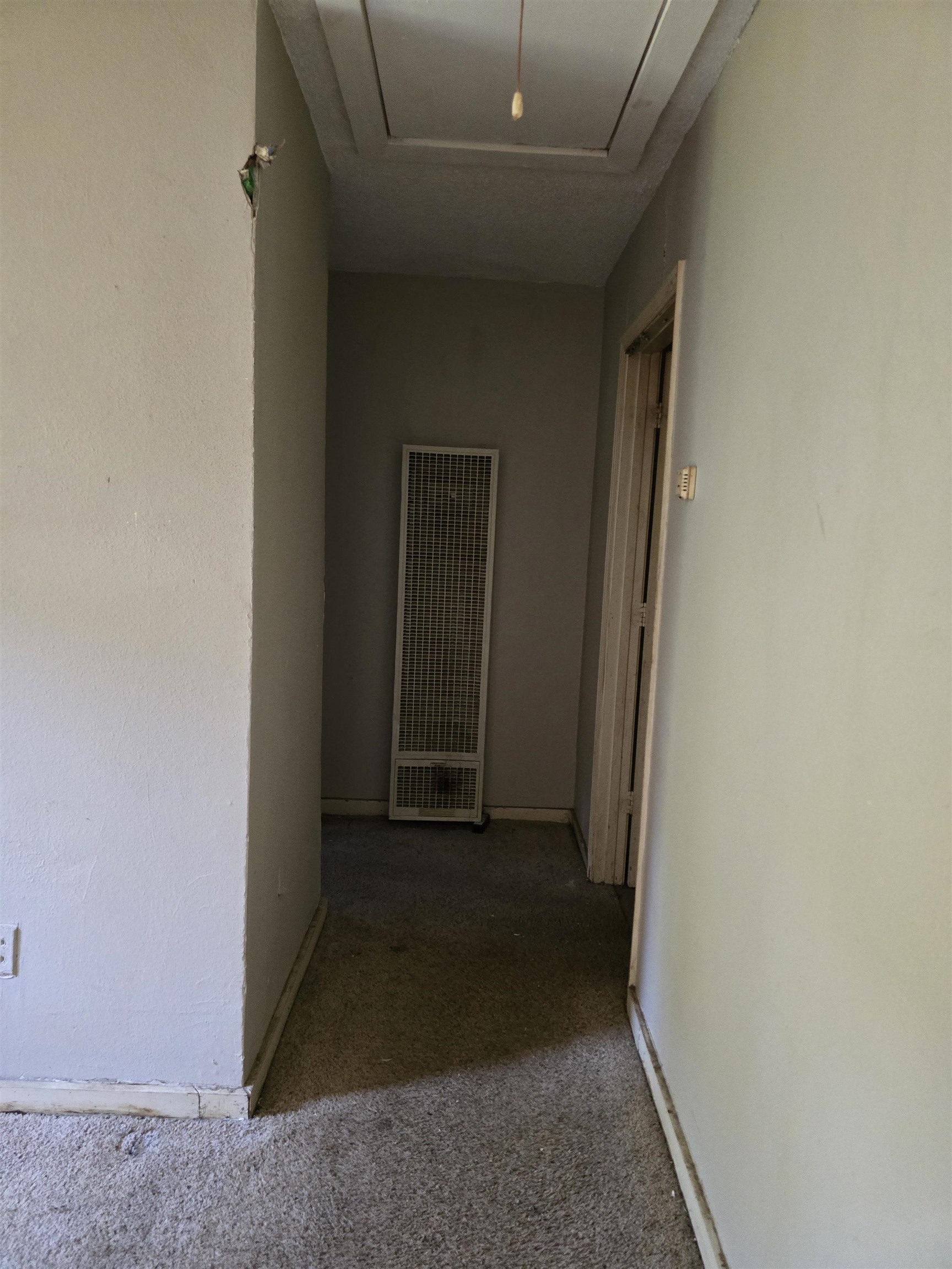 1572 Hanauer Street Memphis, TN 38109 - Photo 19 of 39 Hall featuring a heating unit, attic access, and carpet flooring