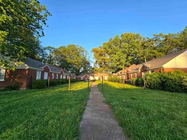 a view of a street with a big yard