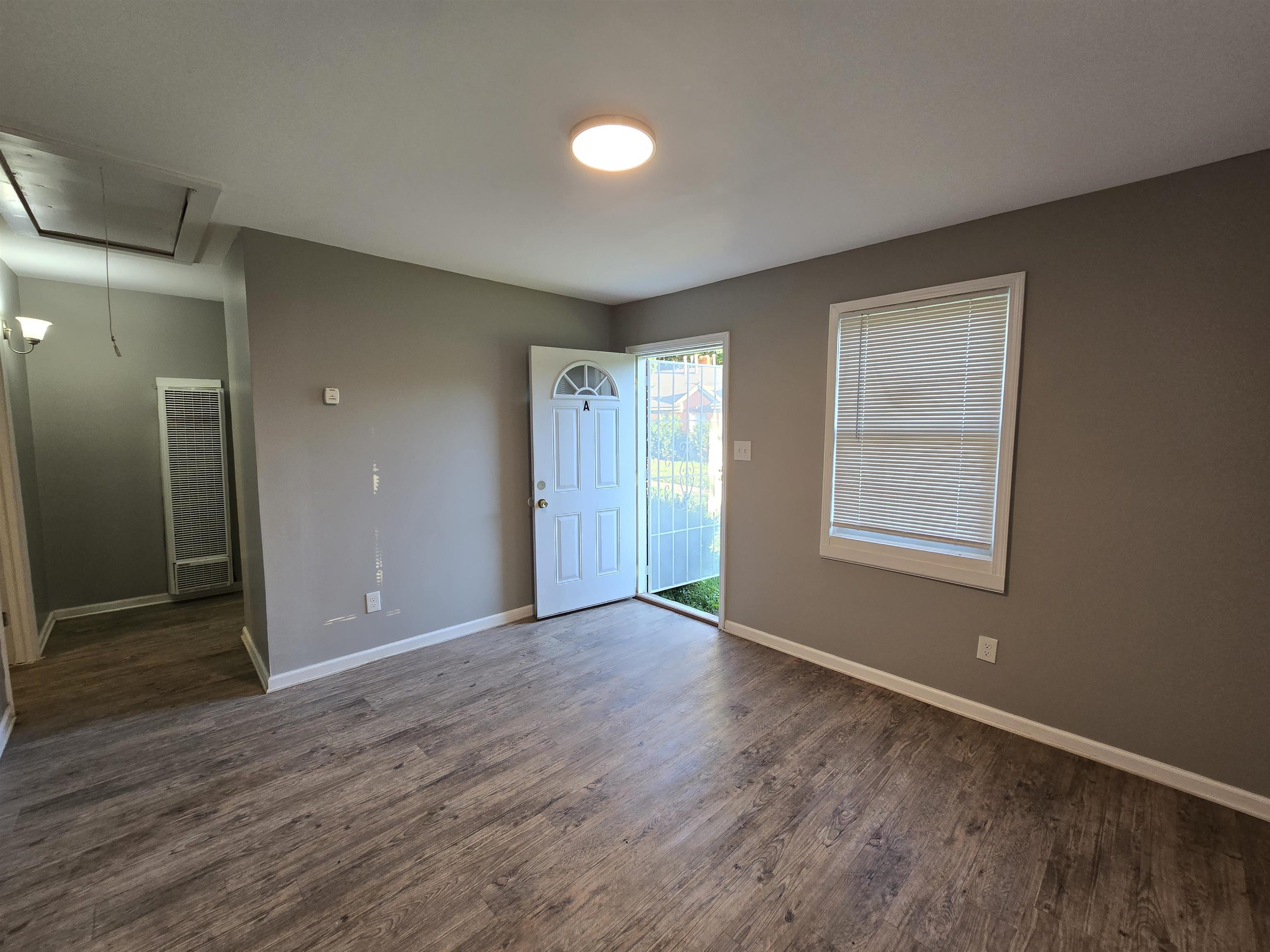 1572 Hanauer Street Memphis, TN 38109 - Photo 6 of 39 an empty room with wooden floor and windows